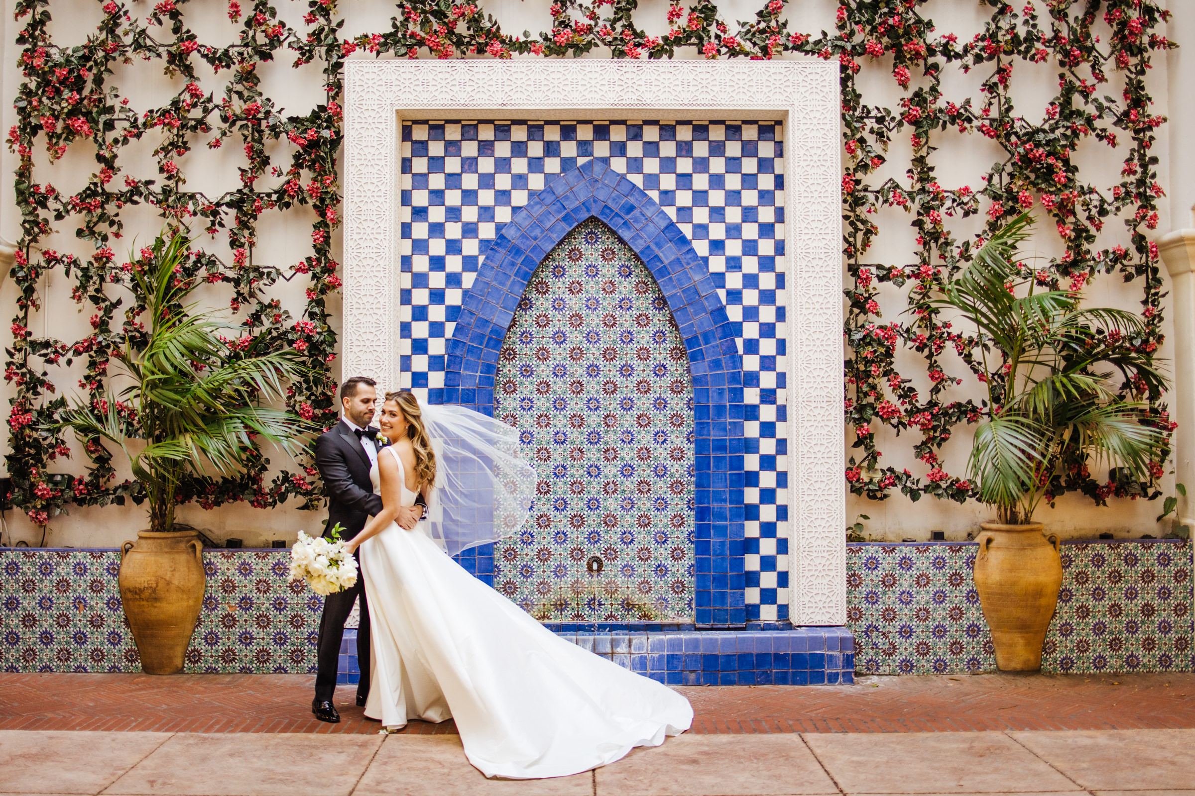 wedding couple posed with classic Santa Barbara fountain architecture 