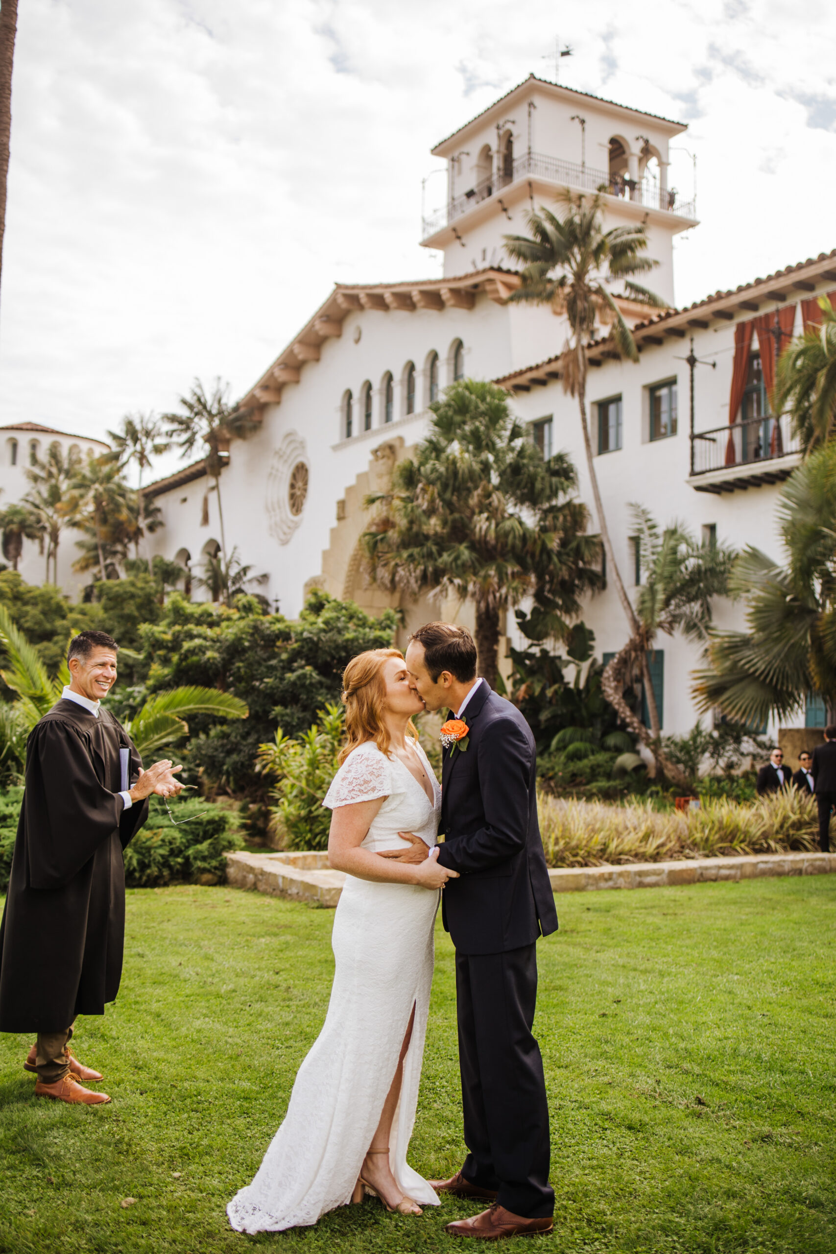 bride and groom kiss on lawn at Santa Barbara County Courthouse