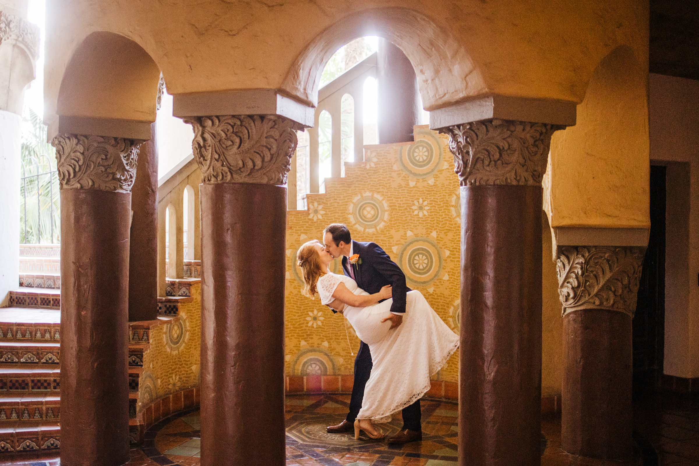 groom dips bride romantically for kiss