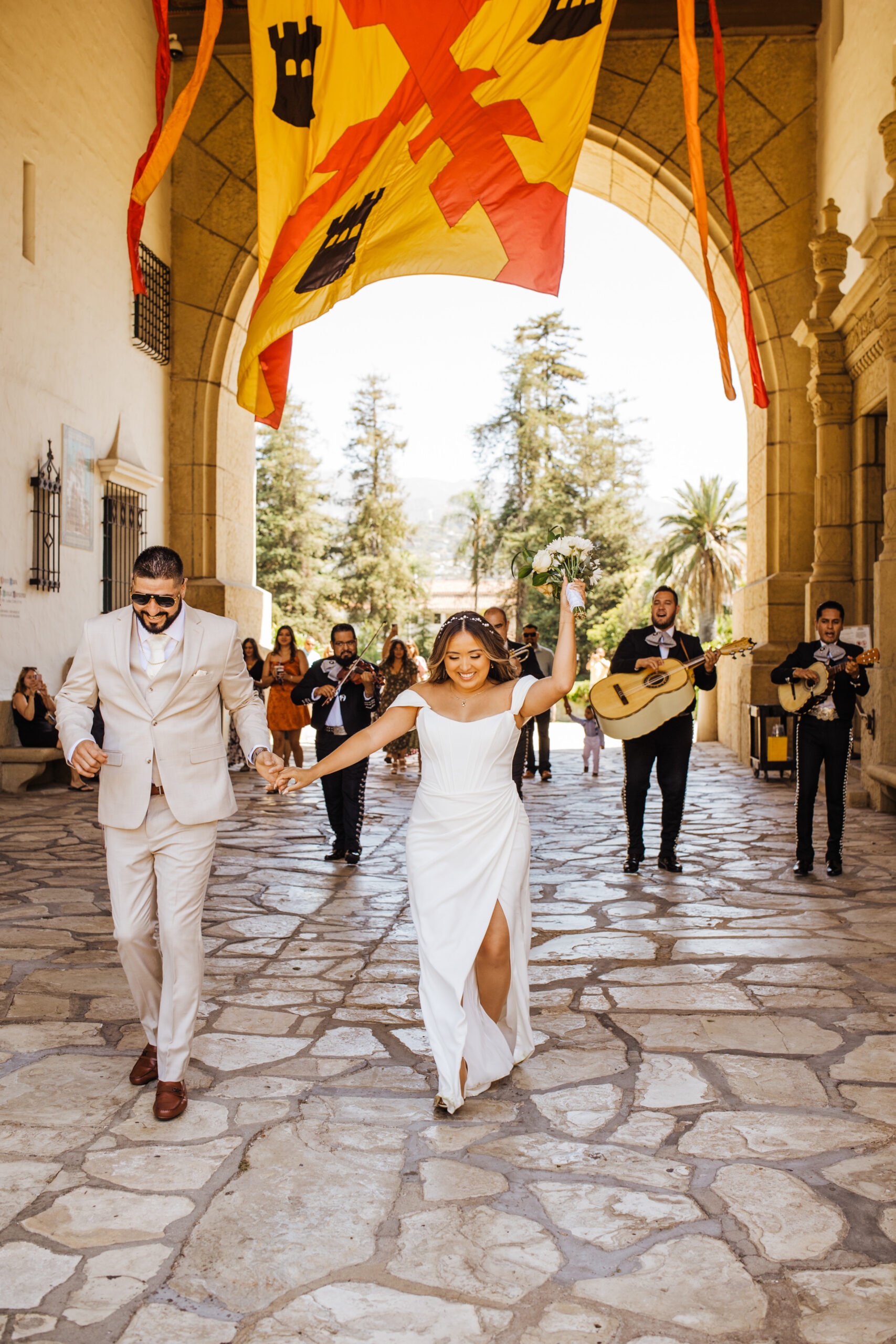 bride and groom followed by mariachi band