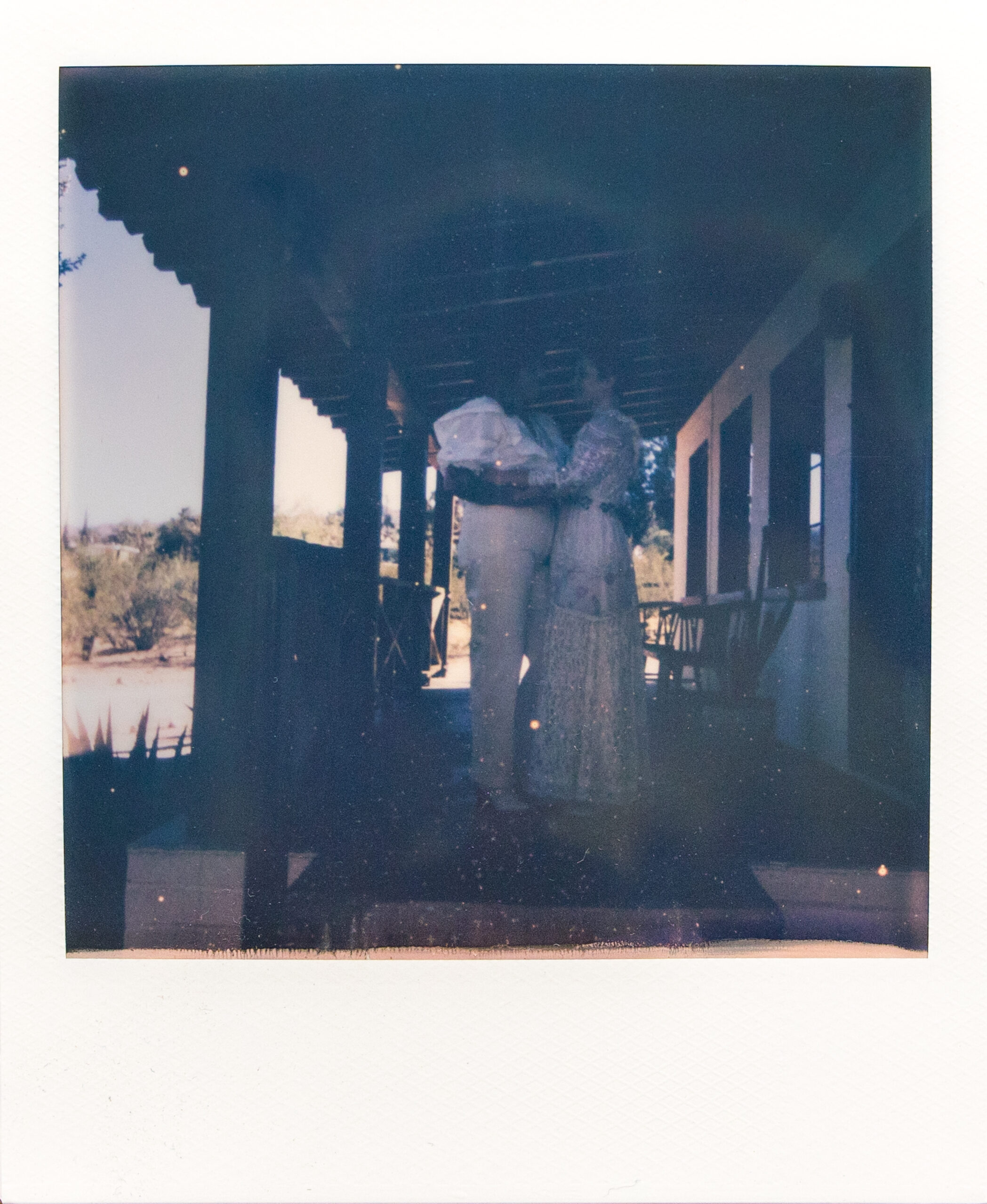 Polaroid with couple on porch