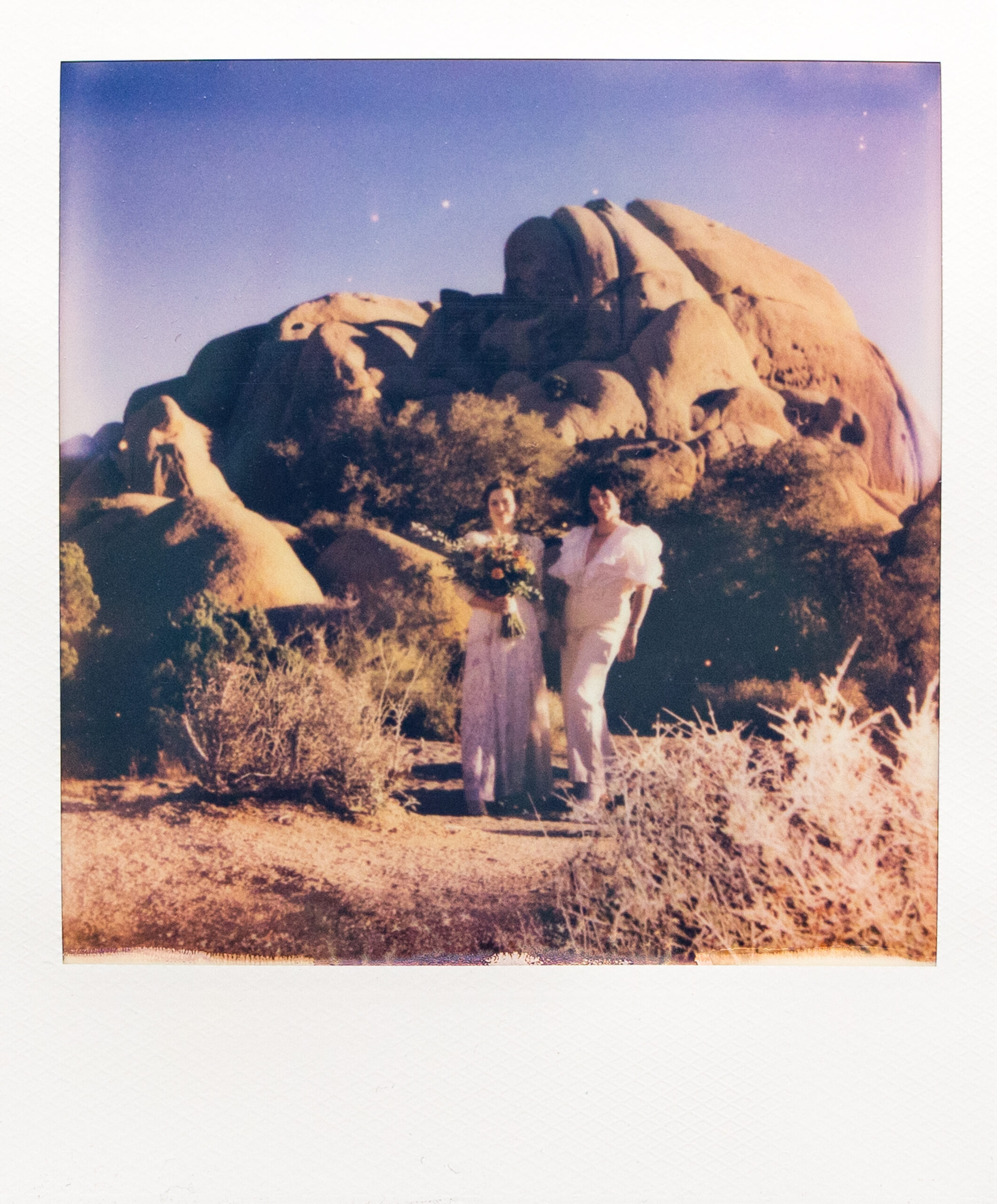 Polaroid of two brides in Joshua Tree