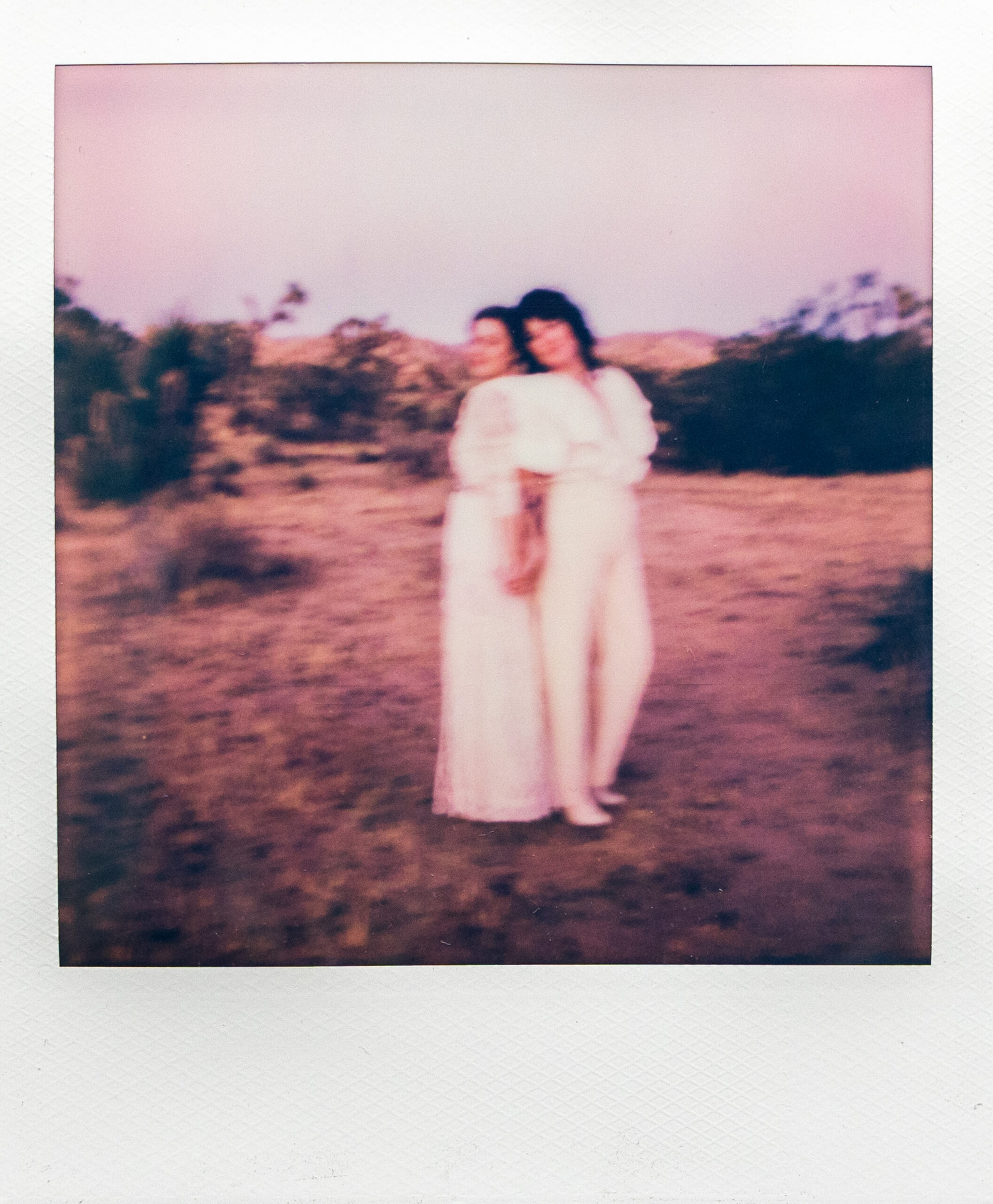 Blurry Polaroid of two brides