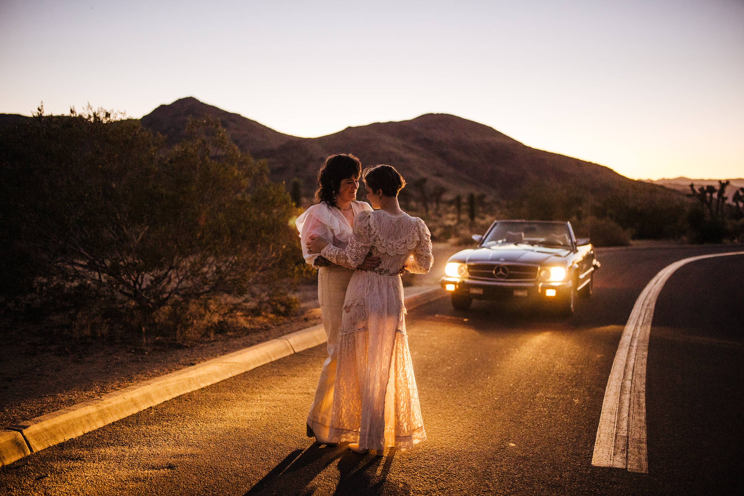 Joshua Tree couple car headlights mountains
