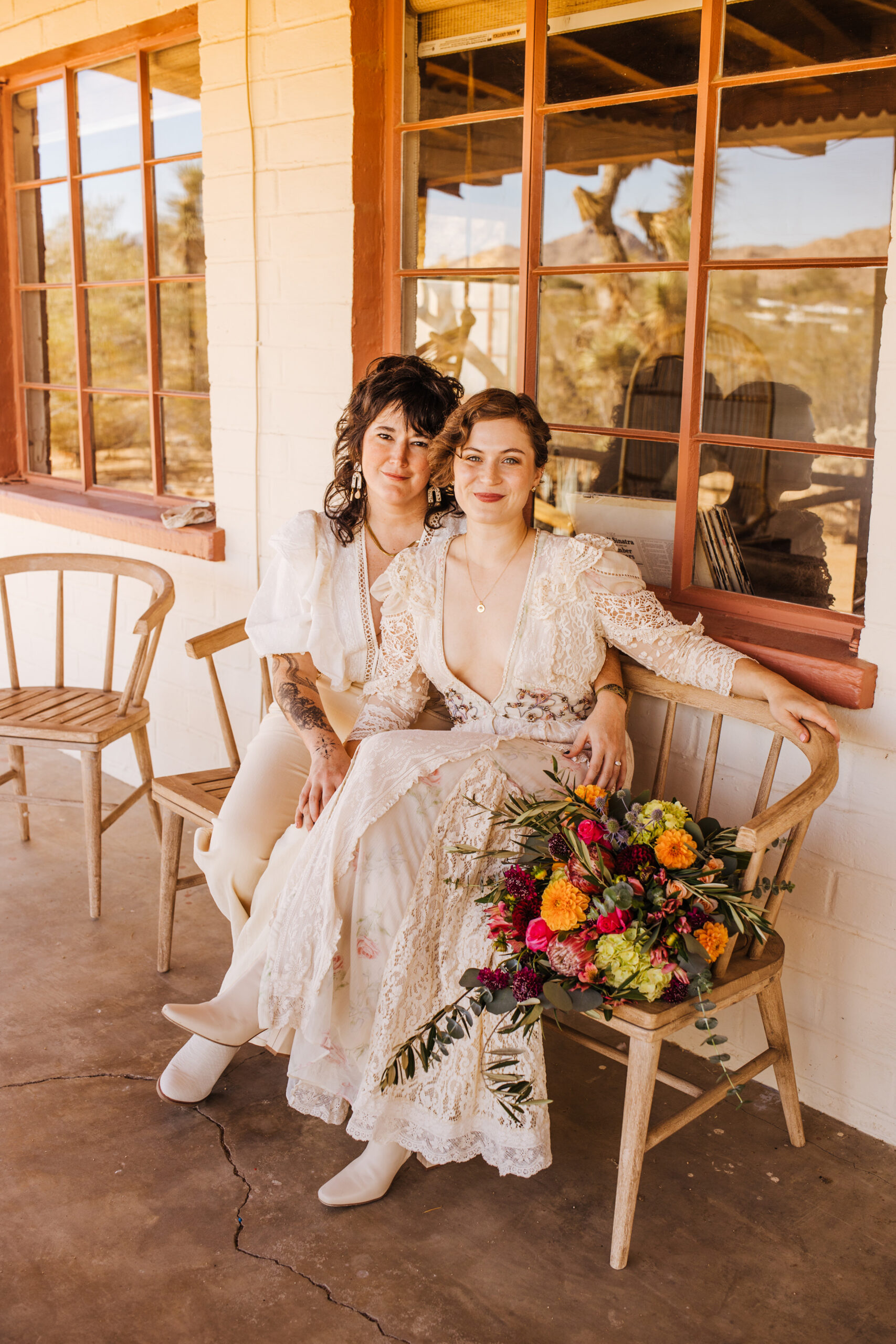 Two brides sitting on porch during Joshua Tree elopement