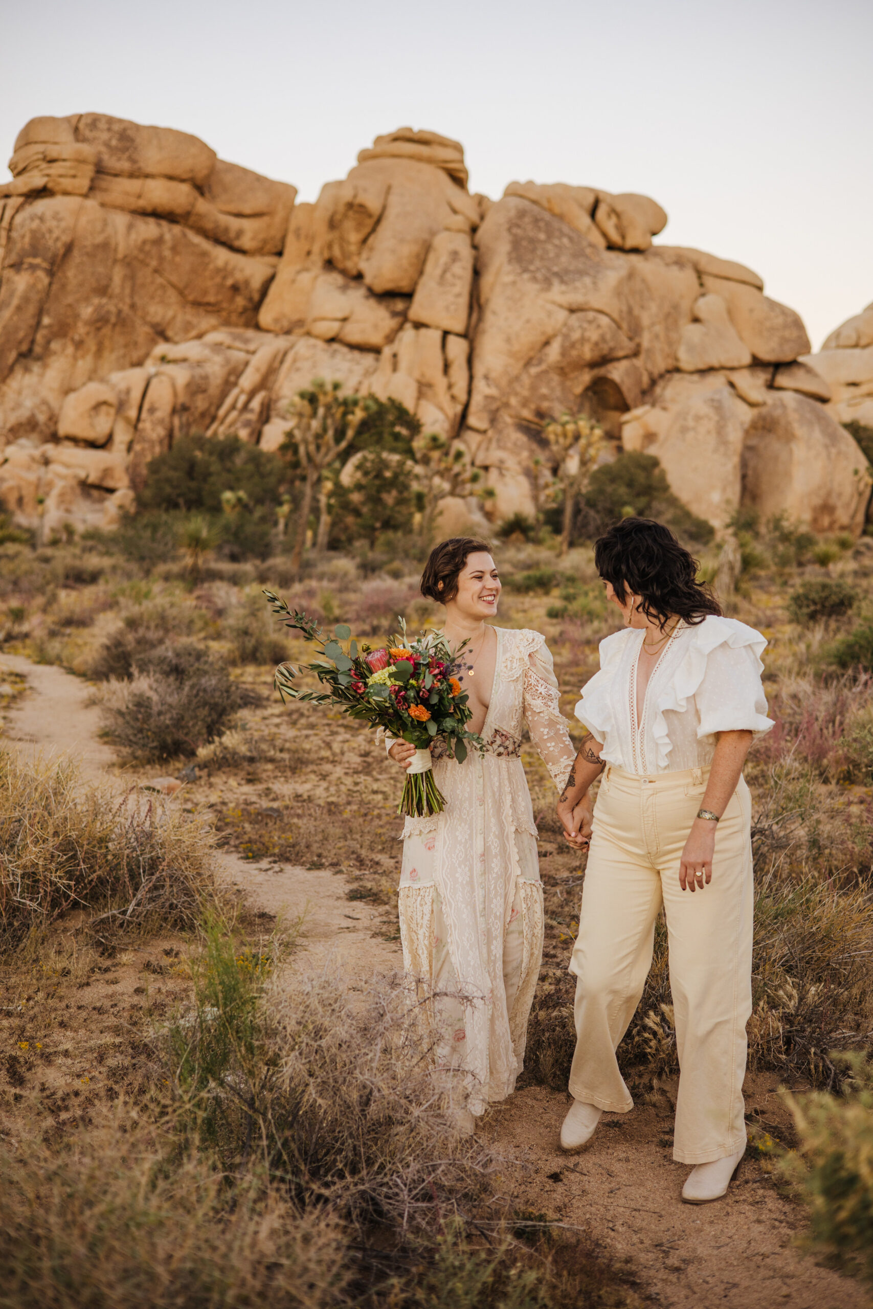 Joshua Tree wedding portraits on path with rocks in background